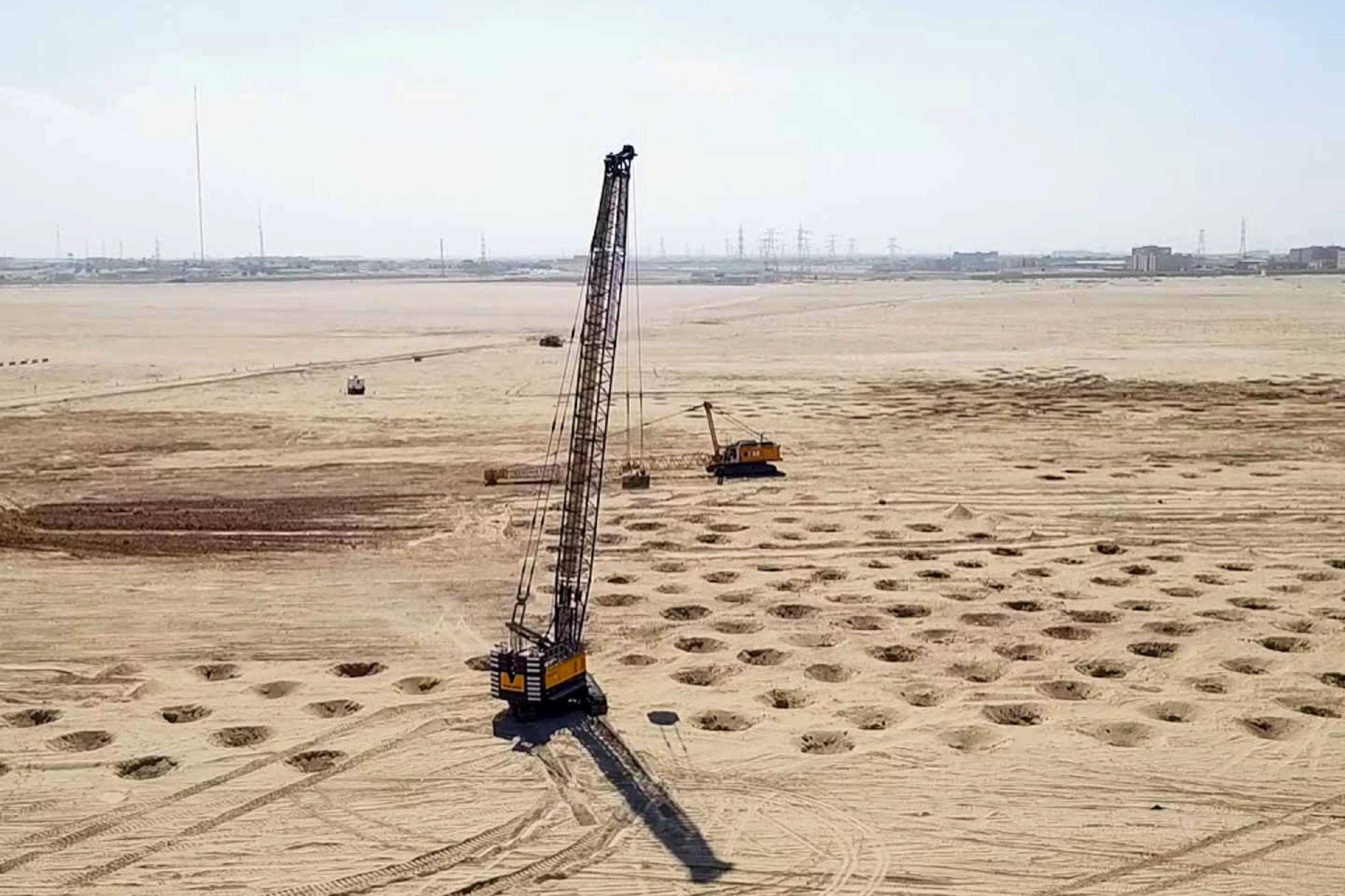 Construction machines on large sandy area