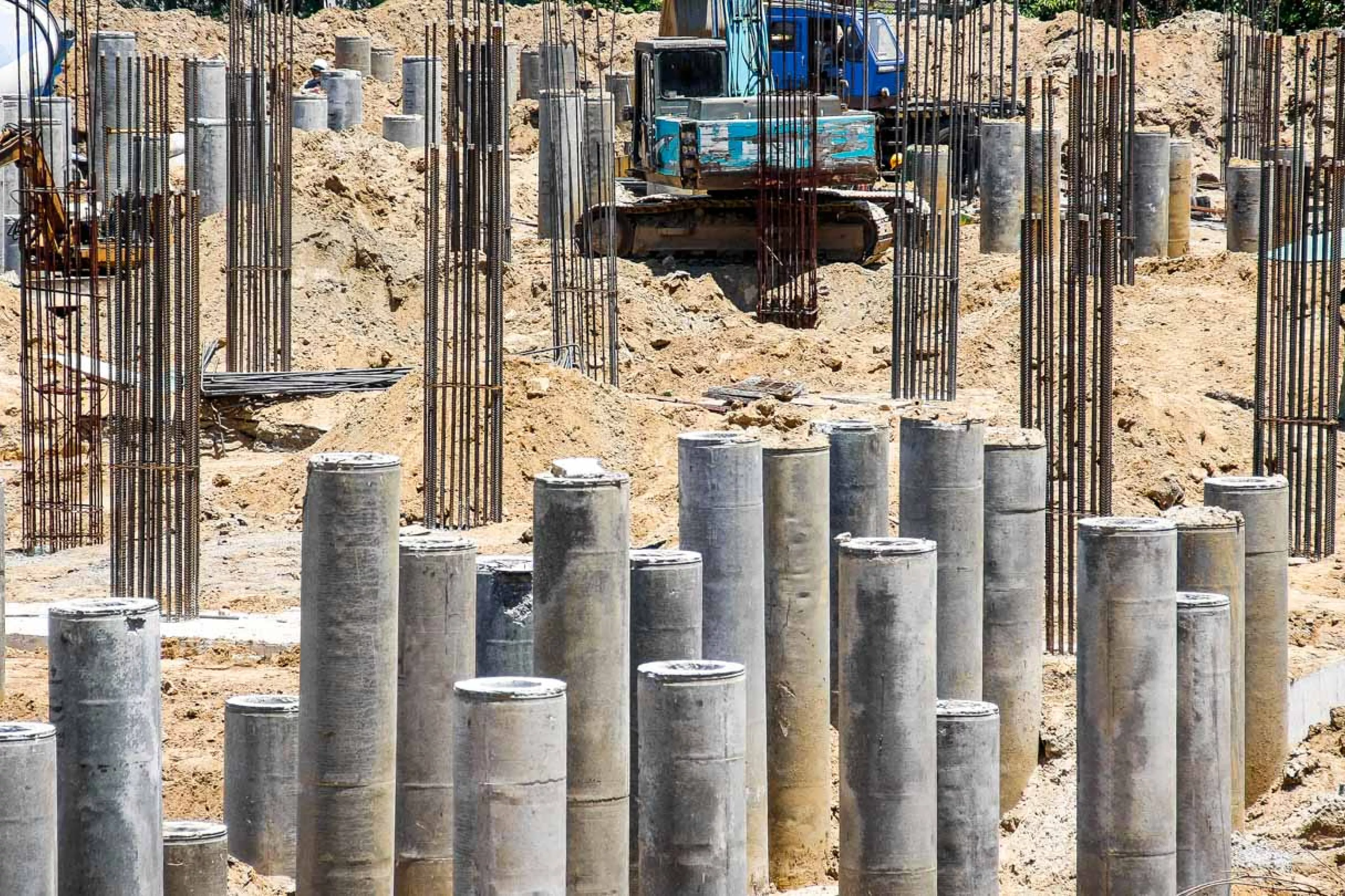 Assorted piles in the ground at pile driving site