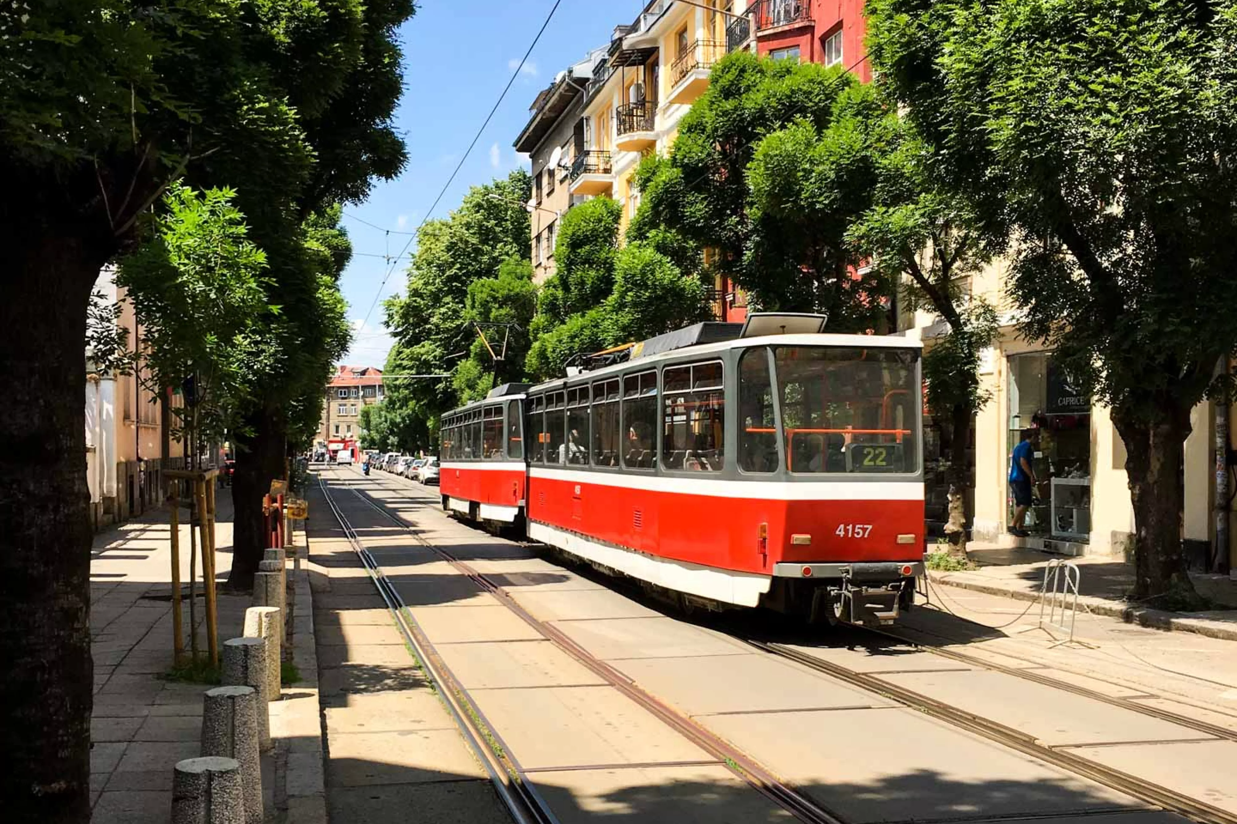 Red trolley on city road